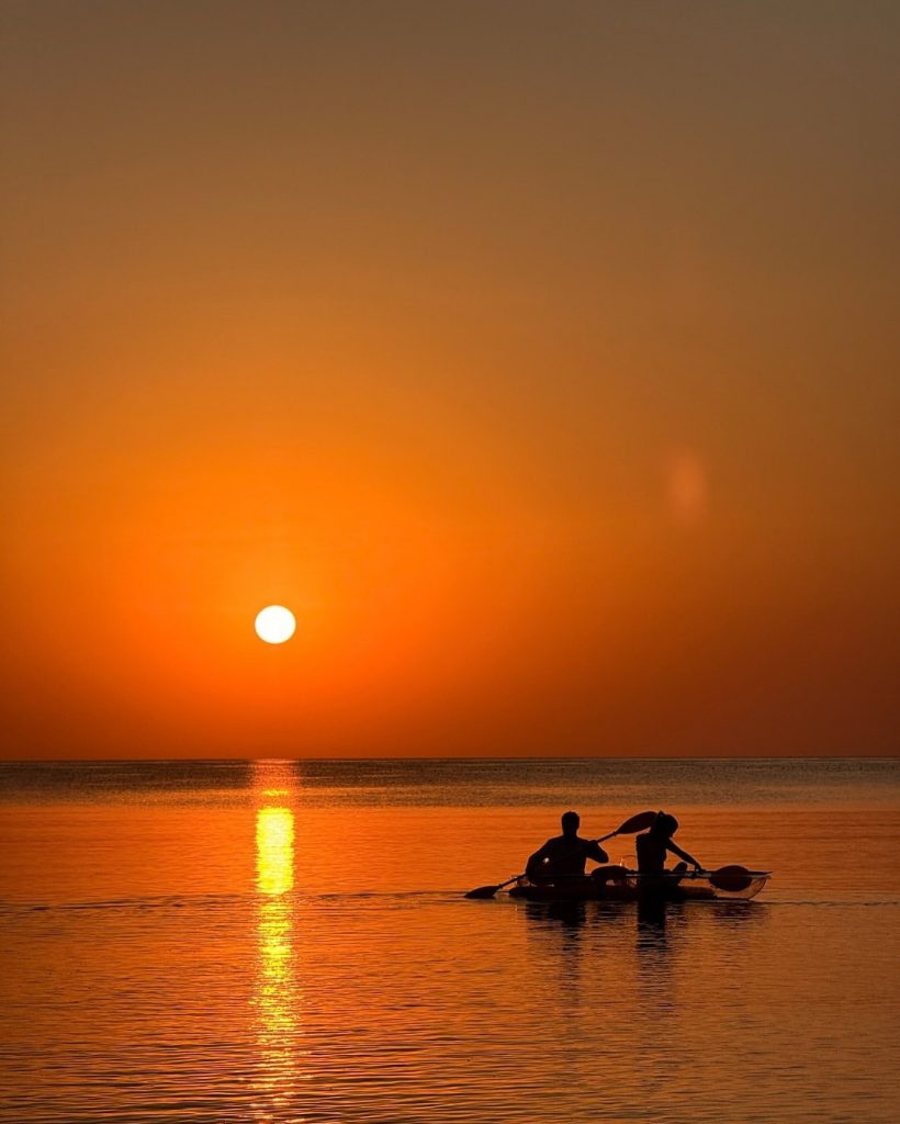 Liveaboard boat at anchor at sunset