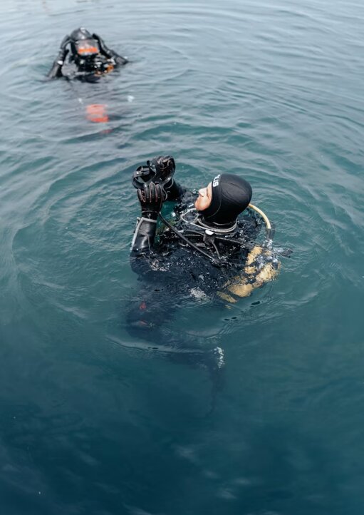 Diver at surface interval reading on liveaboard sundeck