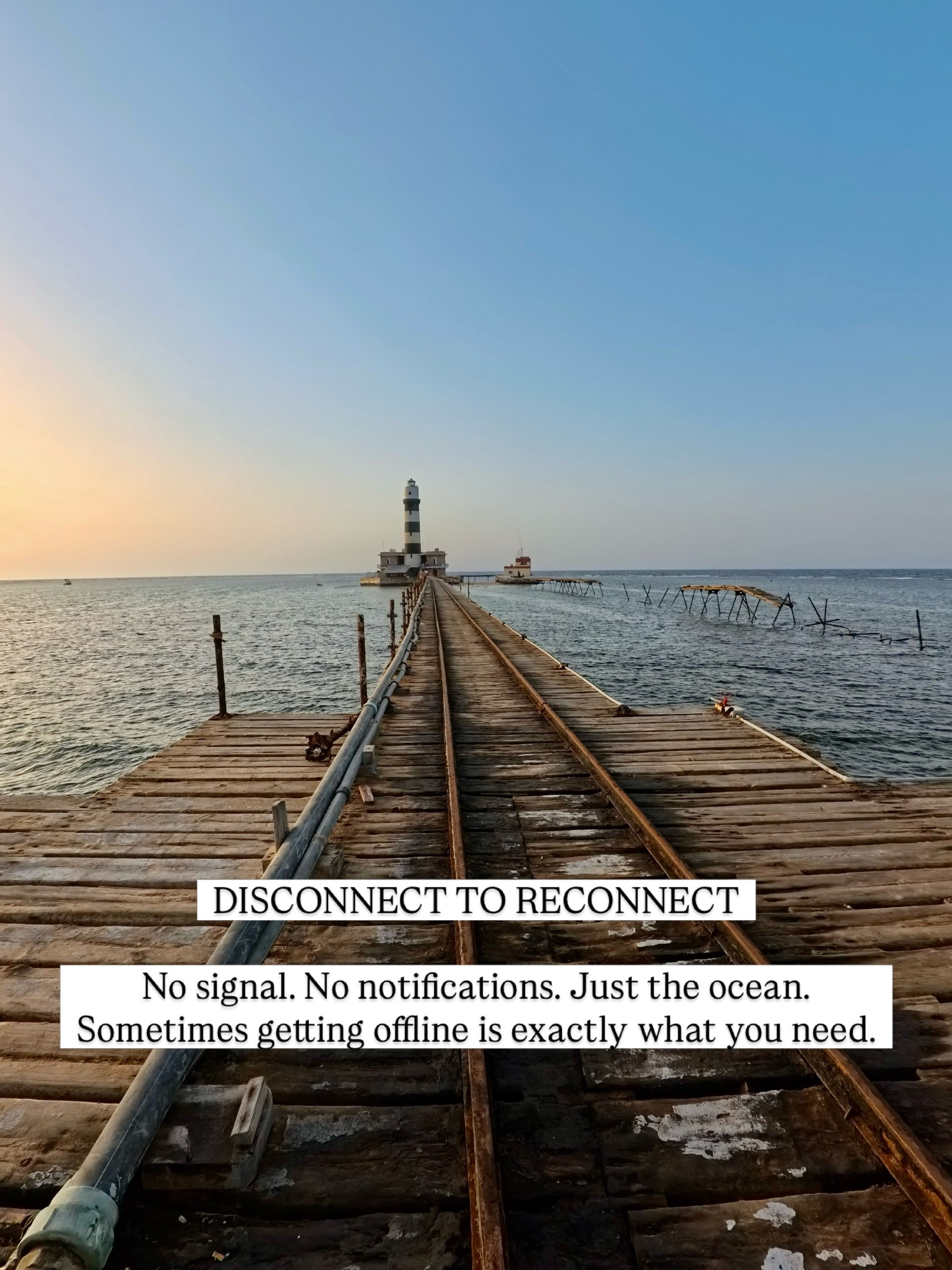 Wooden jetty leading to the Daedalus Reef lighthouse at first light
