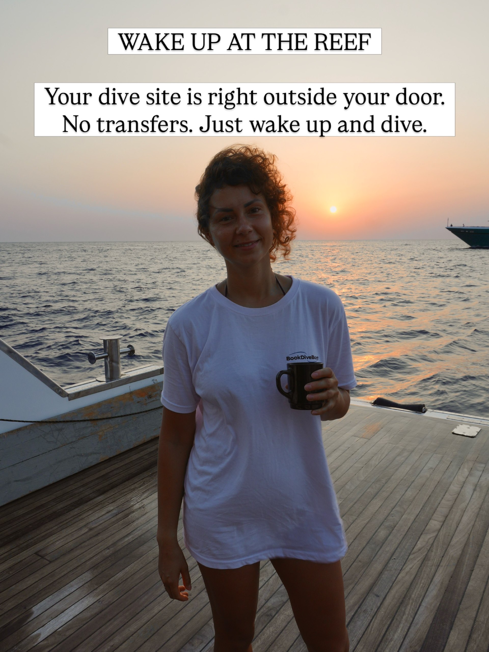 Diver holding a coffee mug on deck at sunrise with another liveaboard on the horizon