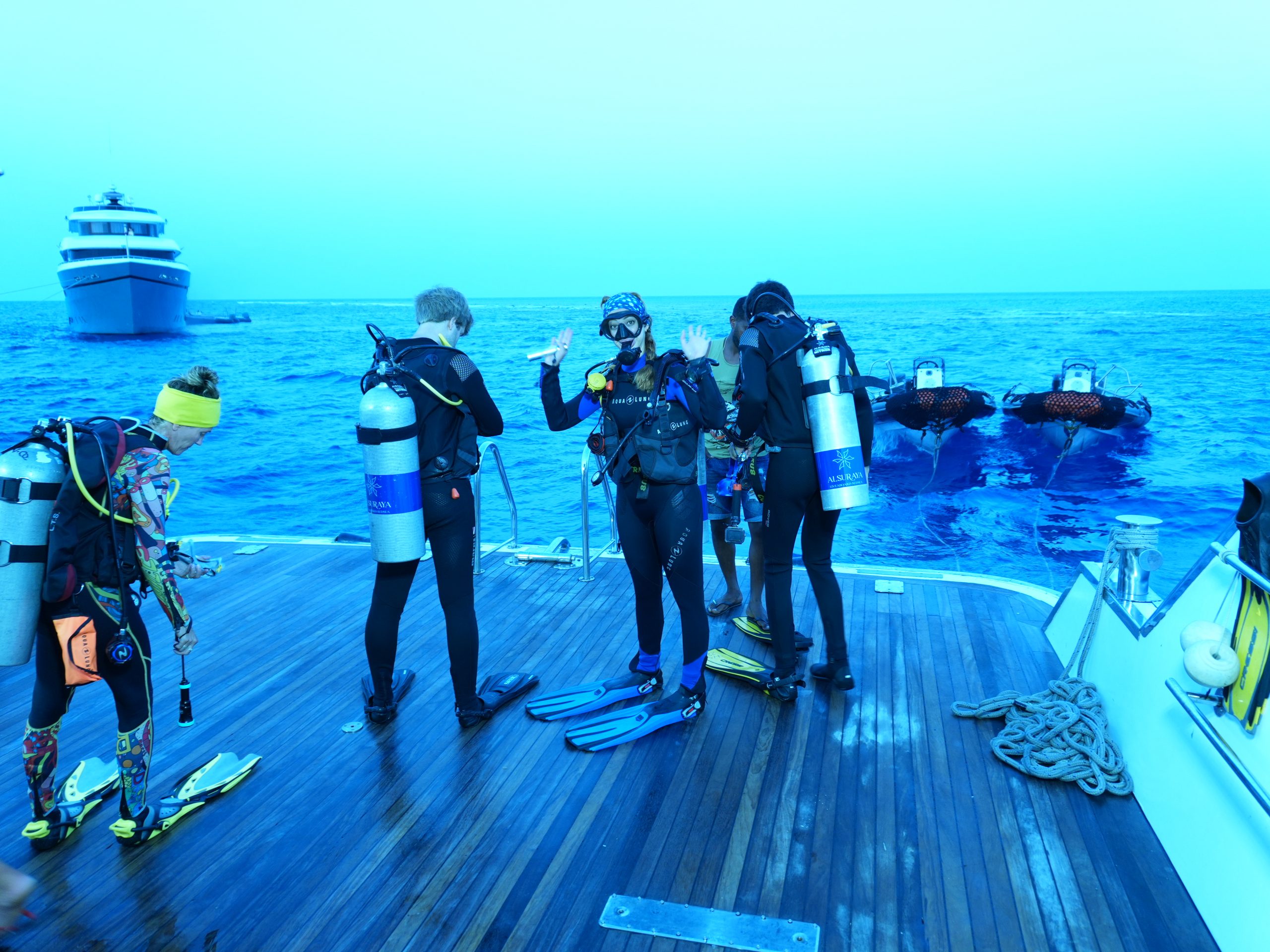 Divers ready to enter the water from a liveaboard dive platform, Egypt