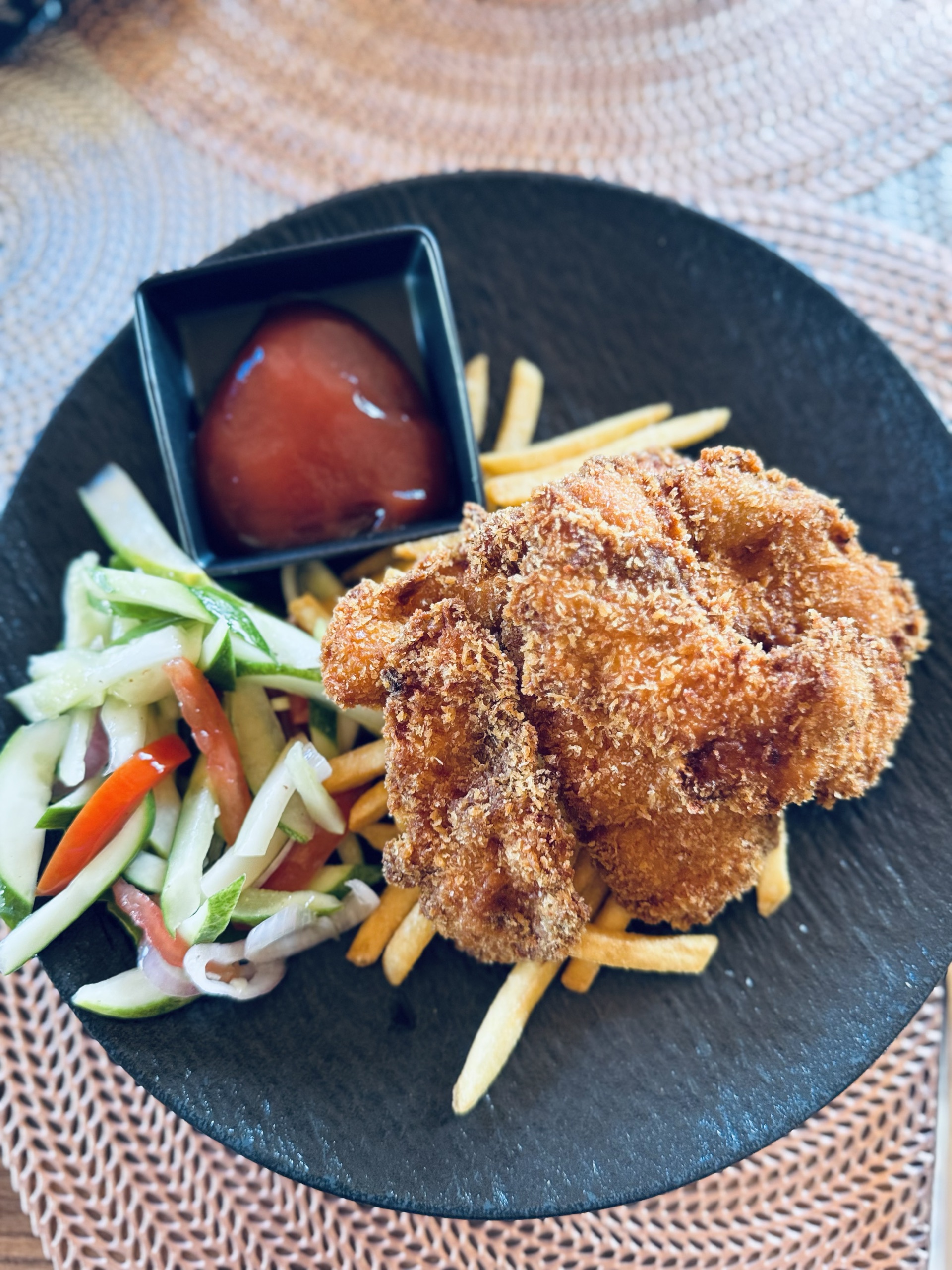 Fried chicken, fries and cucumber salad for lunch in Fuvahmulah
