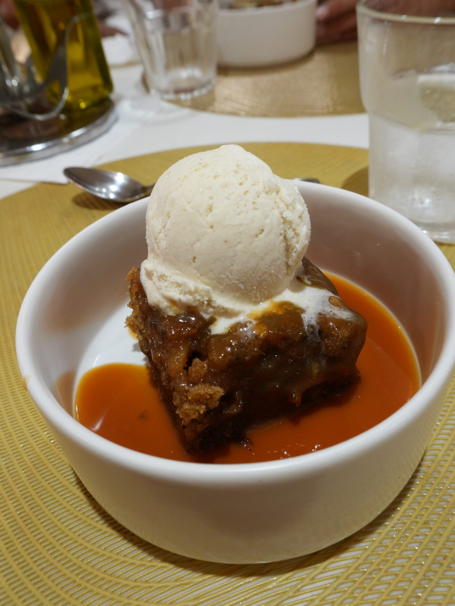 Sticky toffee pudding with vanilla ice cream, liveaboard dessert in Egypt