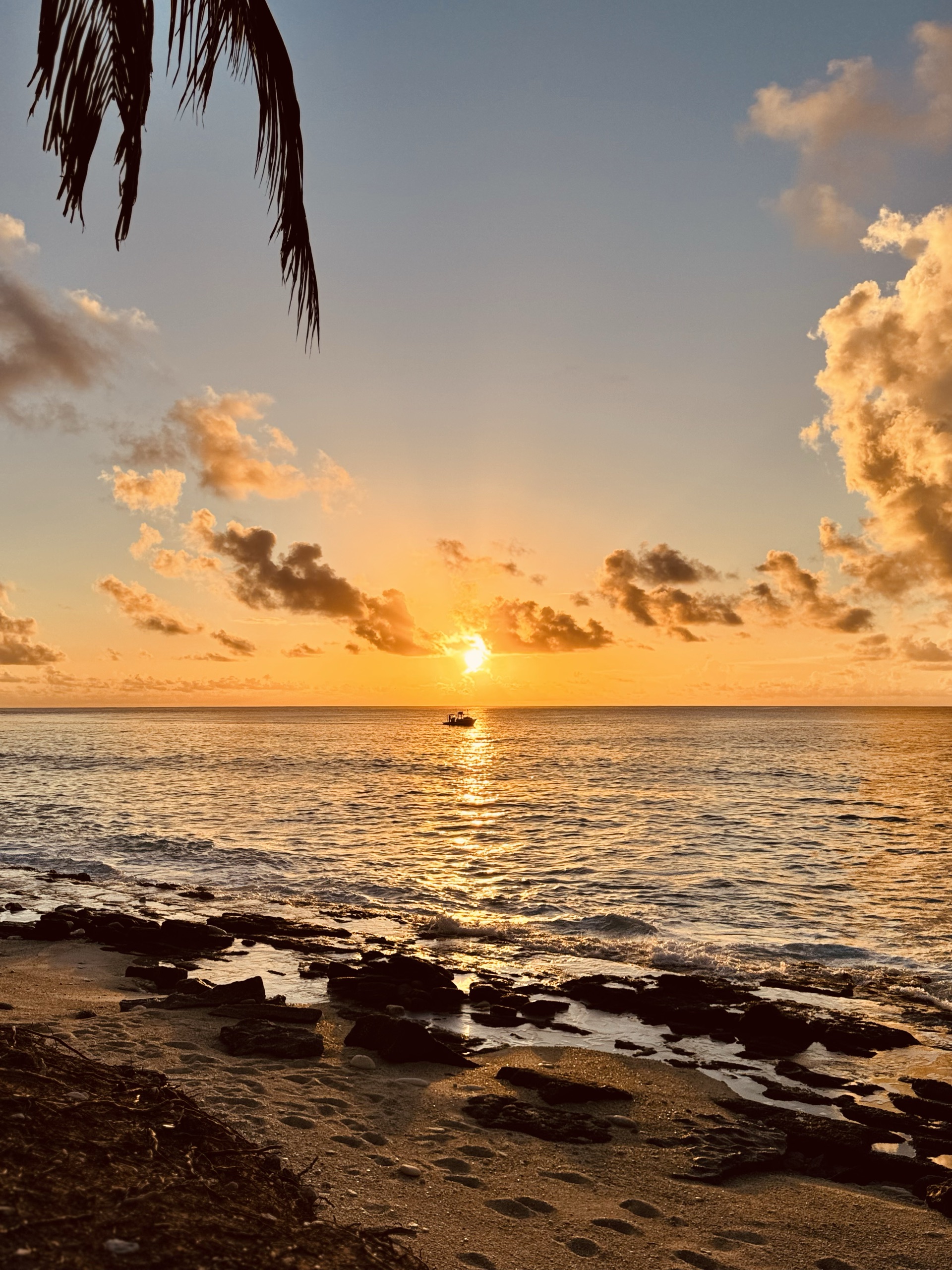 Sunset over the Indian Ocean from a rocky beach, Fuvahmulah