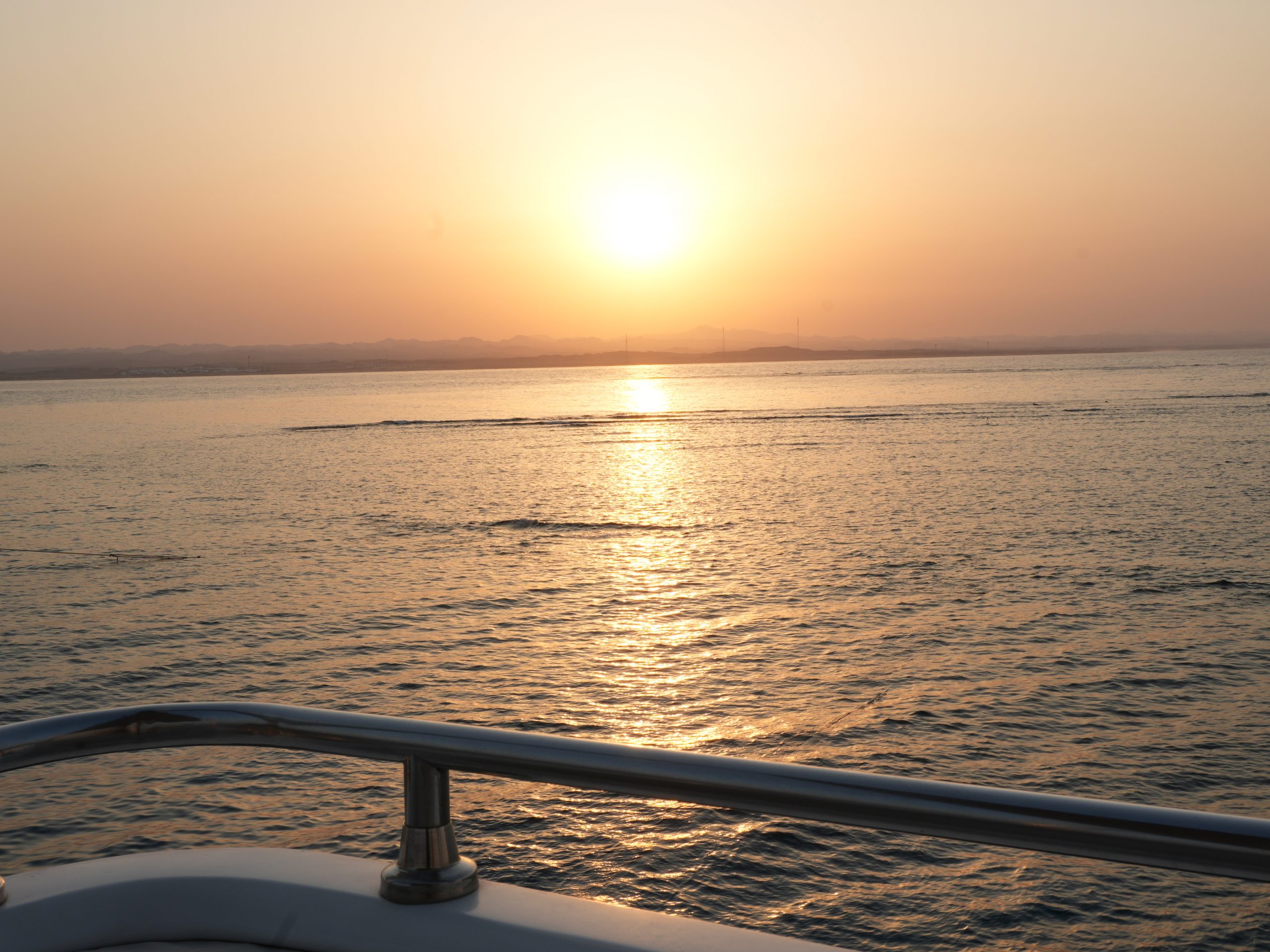 Sunset over the Red Sea from a liveaboard railing, Egypt