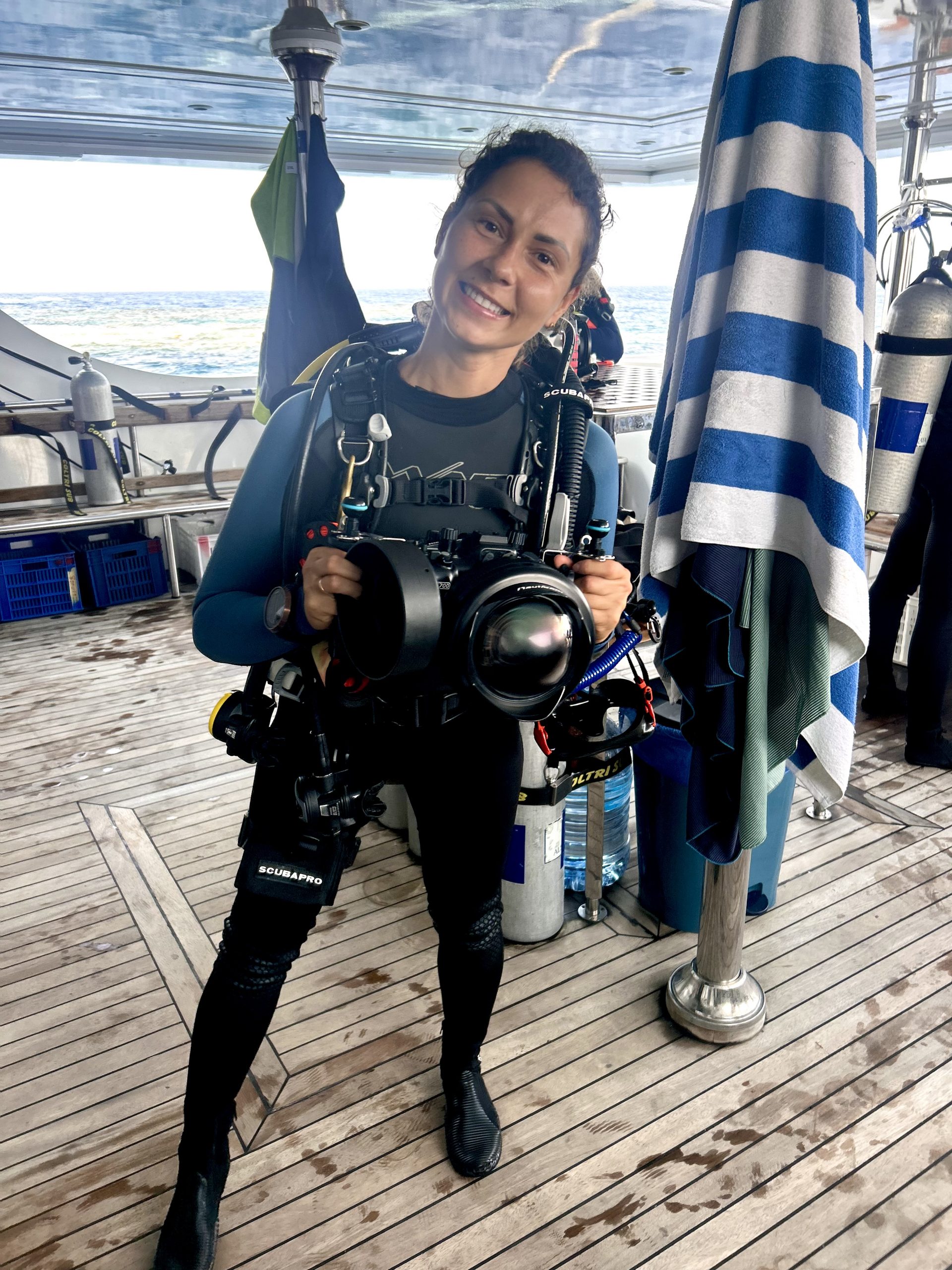 Underwater photographer with a camera housing on a liveaboard deck, Egypt